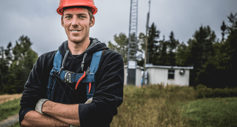 man stanfing in font of a a base station antenna